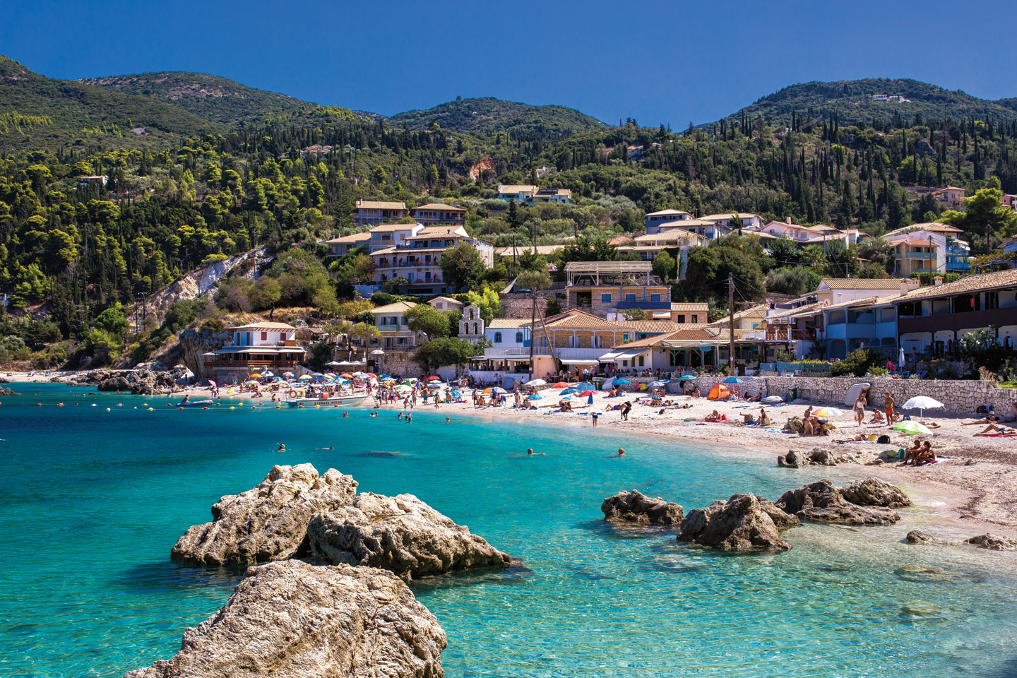 Agios Nikitas, Lefkada | A stone-built seaside settlement by a blue-green sea 